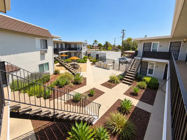 Courtyard landscaping and staircases seen from the upstairs walkway