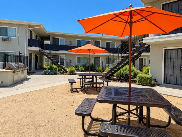 Picnic tables with orange umbrellas in the courtyard