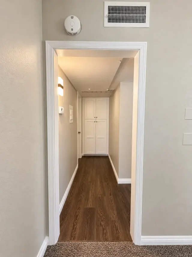 Hallway with wood-style flooring
